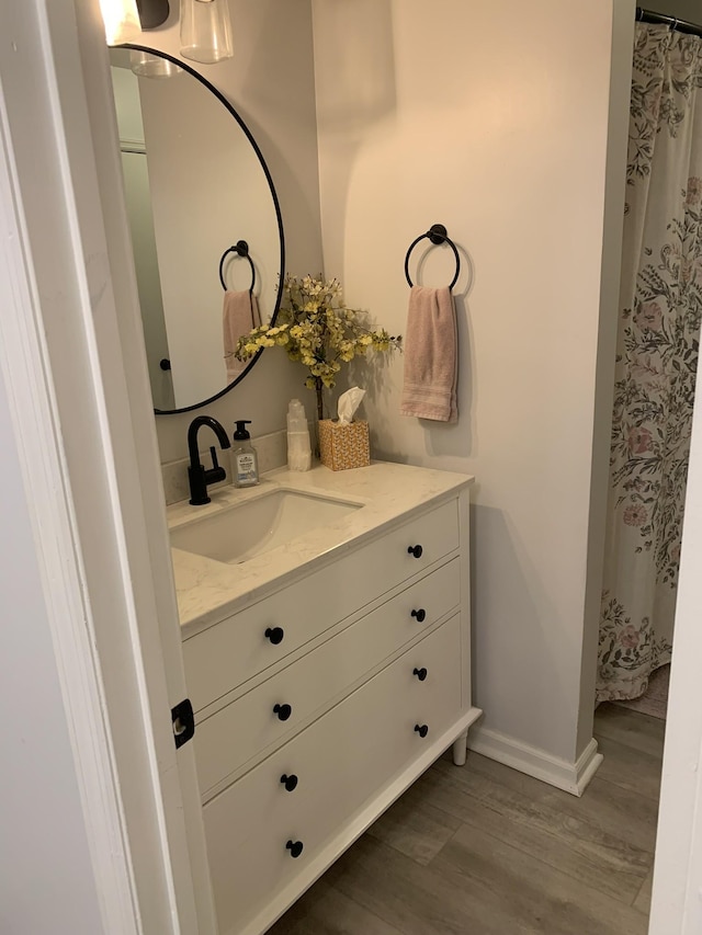 bathroom featuring vanity and wood-type flooring