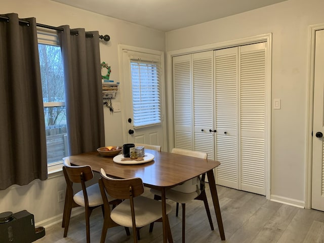 dining area featuring light hardwood / wood-style floors and a healthy amount of sunlight