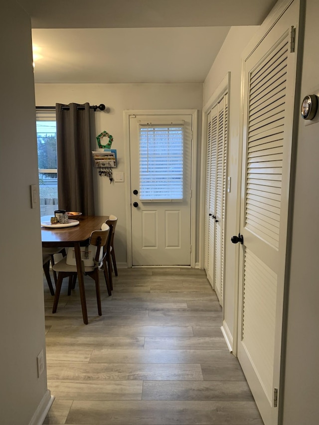 doorway with light wood-type flooring