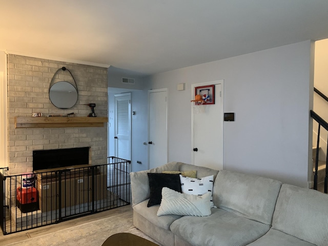 living room with a brick fireplace