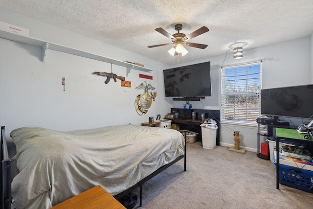 bedroom with a textured ceiling, ceiling fan, and light colored carpet