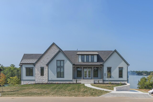 view of front of property featuring french doors and a front lawn