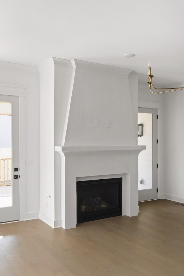 unfurnished living room featuring ornamental molding and light hardwood / wood-style floors