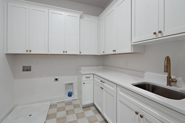 clothes washing area with sink, electric dryer hookup, hookup for a washing machine, and cabinets