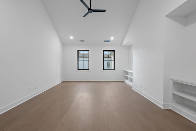 unfurnished living room with lofted ceiling, ceiling fan, hardwood / wood-style flooring, and built in features