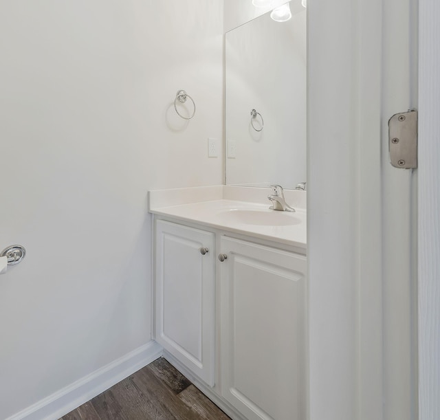 bathroom with hardwood / wood-style flooring and vanity