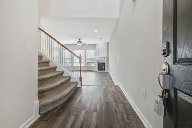 foyer entrance with wood-type flooring and ceiling fan