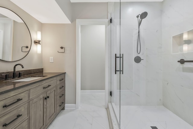 bathroom featuring an enclosed shower and vanity