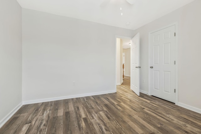 unfurnished bedroom with ceiling fan and dark hardwood / wood-style floors