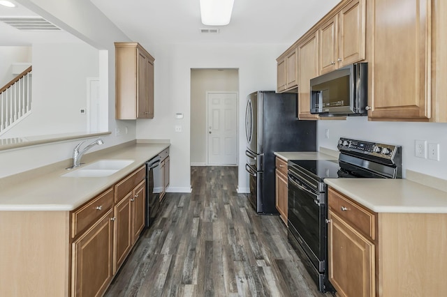 kitchen featuring dark wood-type flooring, black appliances, and sink