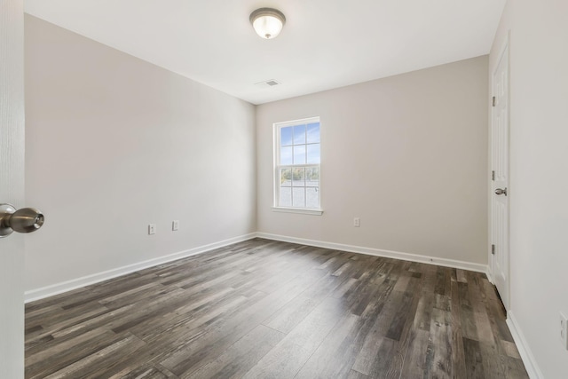 empty room with dark wood-type flooring