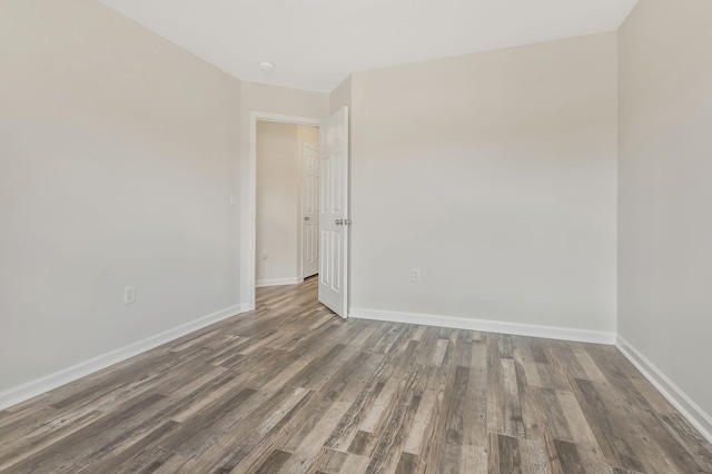 empty room with dark wood-type flooring