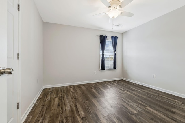 spare room with ceiling fan and dark hardwood / wood-style floors