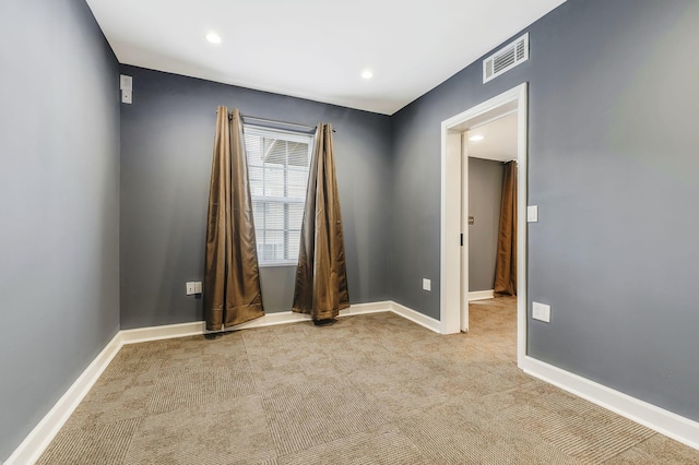 unfurnished room with light carpet