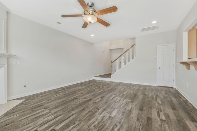 unfurnished living room featuring ceiling fan and dark hardwood / wood-style floors