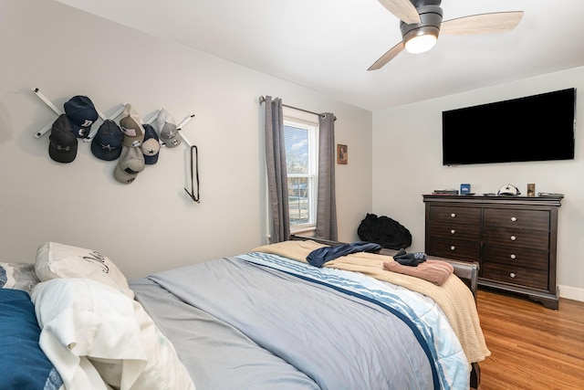 bedroom featuring ceiling fan and light hardwood / wood-style flooring