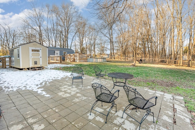 view of patio / terrace featuring a deck and a shed