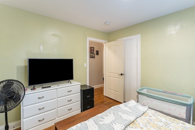 bedroom with hardwood / wood-style floors