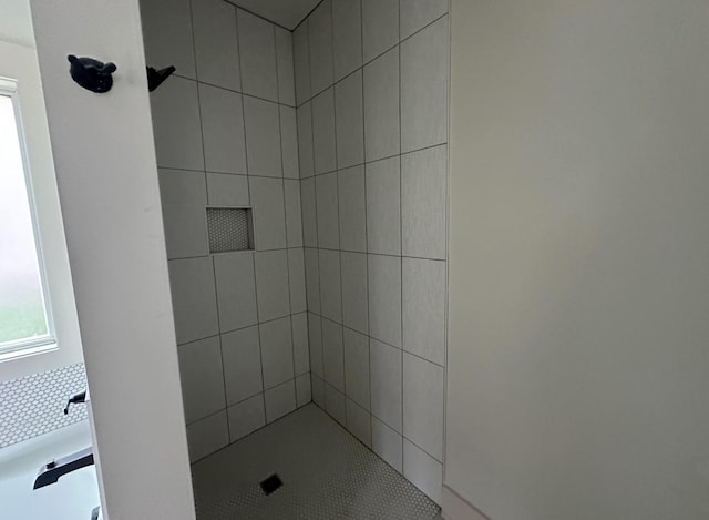 bathroom with tiled shower