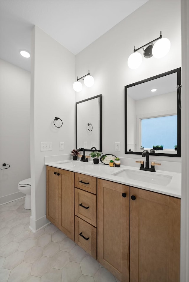 bathroom featuring tile patterned flooring, vanity, and toilet