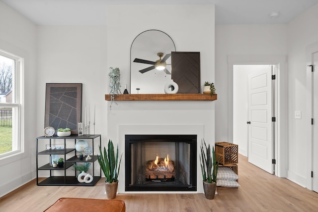 living area featuring hardwood / wood-style floors and ceiling fan