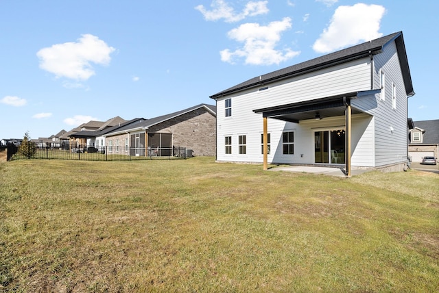 back of property featuring ceiling fan, a yard, and a patio