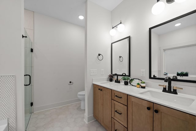 bathroom with vanity, toilet, and a shower with shower door