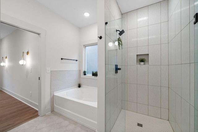 bathroom featuring tile patterned flooring and shower with separate bathtub