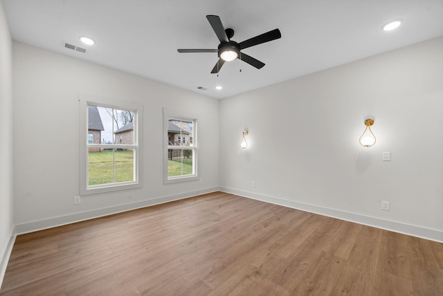 spare room with light hardwood / wood-style flooring and ceiling fan