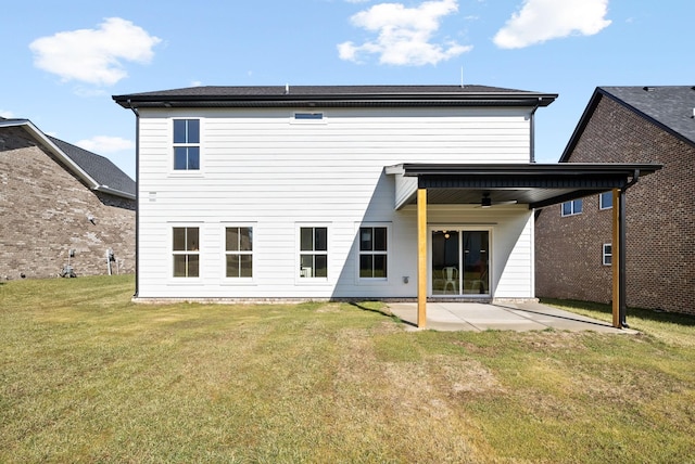 back of house with ceiling fan, a patio, and a lawn