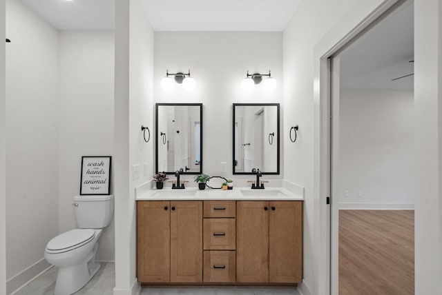 bathroom featuring hardwood / wood-style flooring, vanity, and toilet