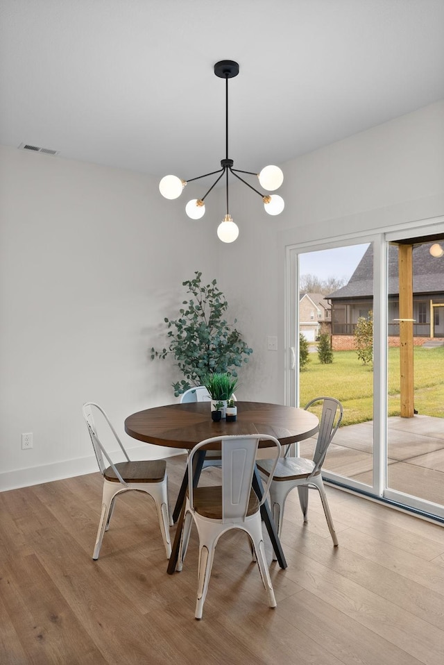 dining space featuring a chandelier and light hardwood / wood-style floors