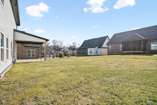 view of yard with a patio area and a sunroom