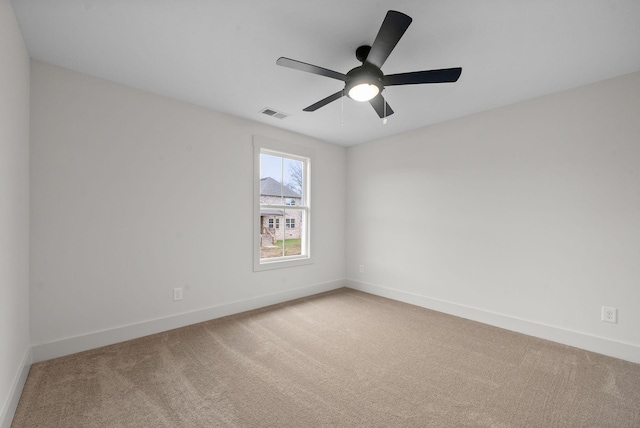 empty room featuring ceiling fan and carpet flooring