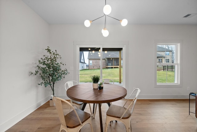 dining space with light hardwood / wood-style flooring