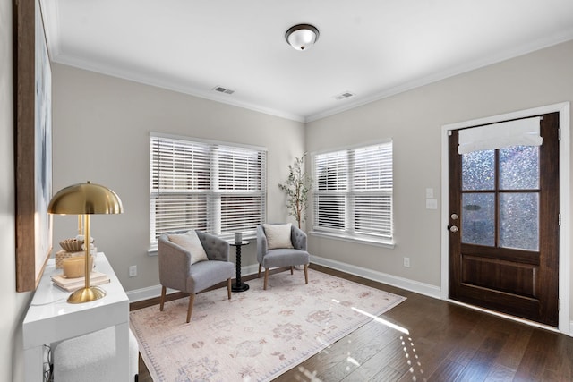 sitting room featuring dark wood-type flooring and ornamental molding