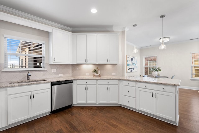 kitchen featuring white cabinets, sink, backsplash, hanging light fixtures, and stainless steel dishwasher