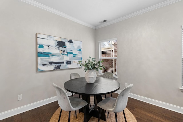 dining space featuring crown molding and hardwood / wood-style flooring