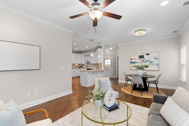 living room featuring ceiling fan, dark hardwood / wood-style flooring, and crown molding