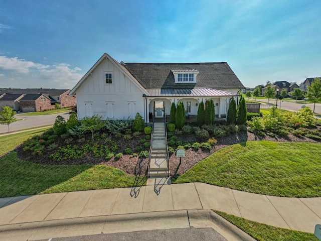 view of front of property with covered porch and a front yard