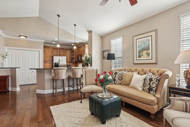 living room featuring vaulted ceiling, dark hardwood / wood-style flooring, ceiling fan, and a wealth of natural light