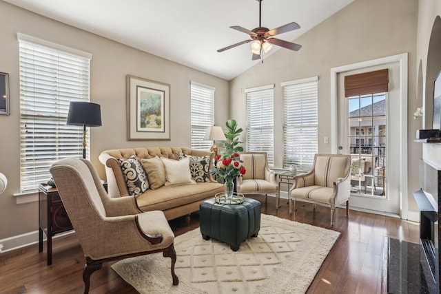 living room featuring a high end fireplace, wood-type flooring, ceiling fan, and vaulted ceiling