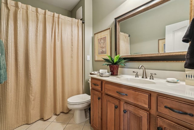 bathroom featuring toilet, tile patterned flooring, and vanity