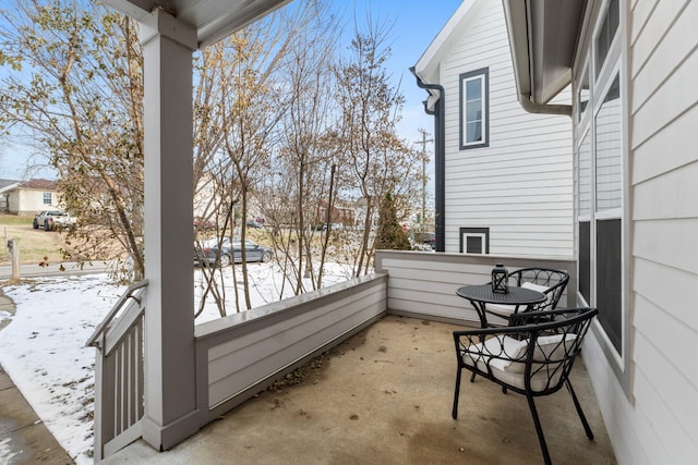 view of snow covered back of property