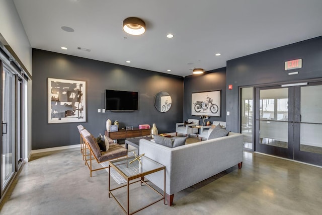 living room featuring concrete floors and french doors