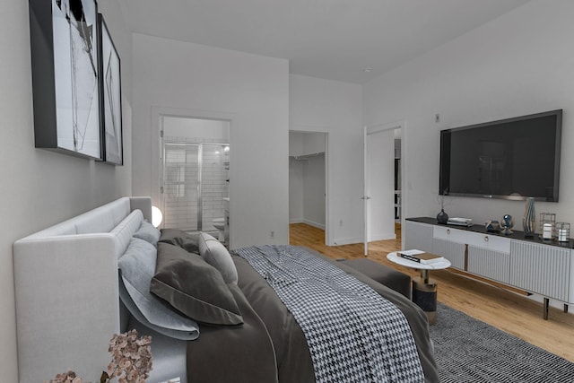 bedroom featuring light hardwood / wood-style floors and a spacious closet