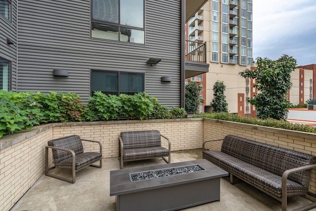 view of patio / terrace with an outdoor living space with a fire pit