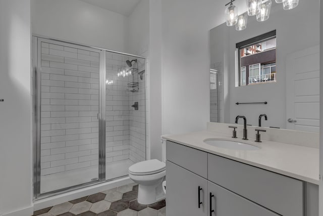 bathroom featuring toilet, tile patterned flooring, an enclosed shower, and vanity