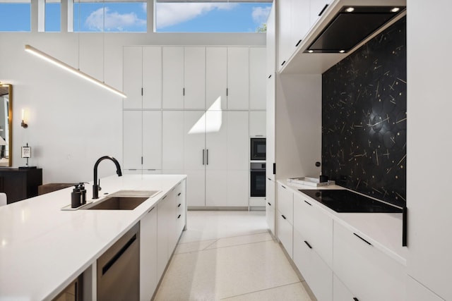 kitchen featuring sink, decorative backsplash, black appliances, and white cabinetry