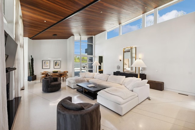 living room featuring a high ceiling and wood ceiling